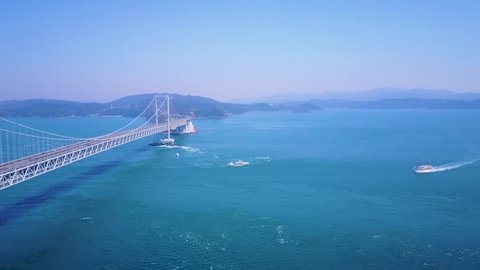 Aerial, Great Naruto Bridge in Tokushima Japan. Spring weather forming whirlpools below which are a popular tourist spot.