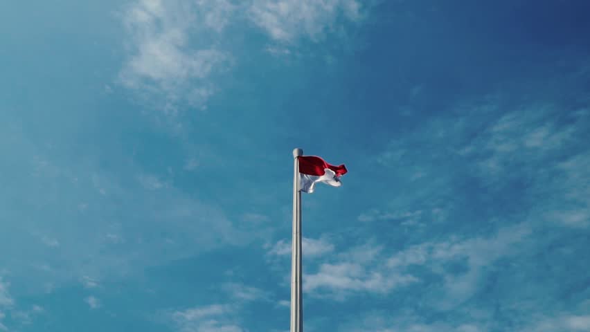 Flag of Indonesia in blue sky Royalty-Free Stock Footage #1012927496