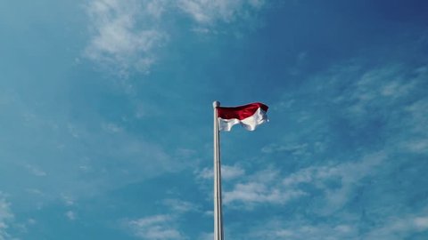 Flag of Indonesia in blue sky