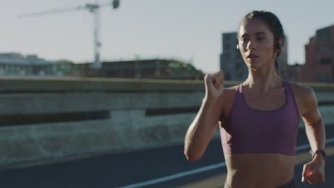 slow motion athlete woman running sprinting training intense cardio endurance workout focused female runner wearing fitness tracker