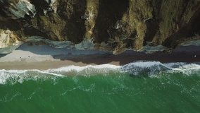 Drone Aeraial video footage of a sea coast with waves hitting the beach Etretat, d'Etretat