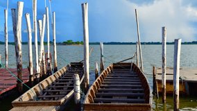 4K time lapse video of the wooden boats in the Kwan Phayao lake, Thailand.