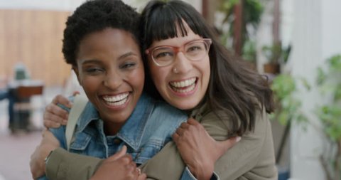 portrait of young woman embracing friend multi ethnic girlfriends hugging enjoying friendship hang out together laughing cheerful