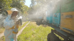bee-maker beekeeper man working of a smoke pipe  