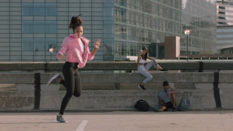 dancing woman young hip hop dancer performing freestyle moves multi ethnic friends watching enjoying urban dance practice using smartphone taking video sharing on social media