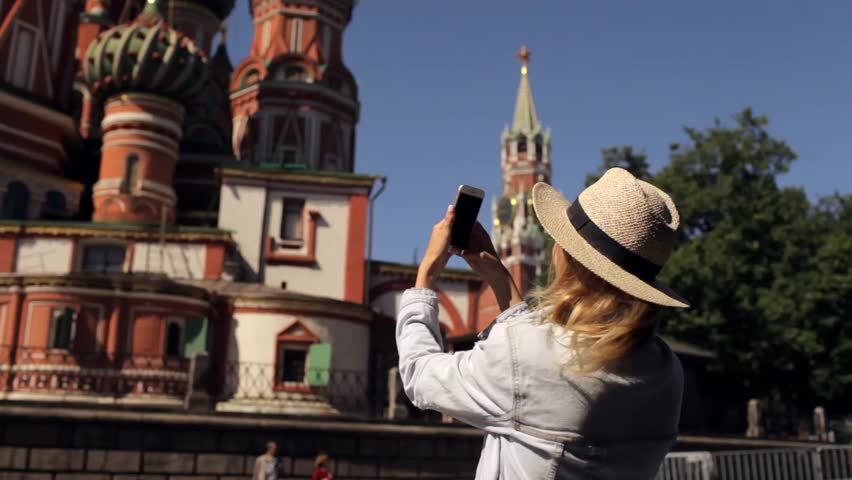 girl is taking pictures on the phone temple in the center of Moscow