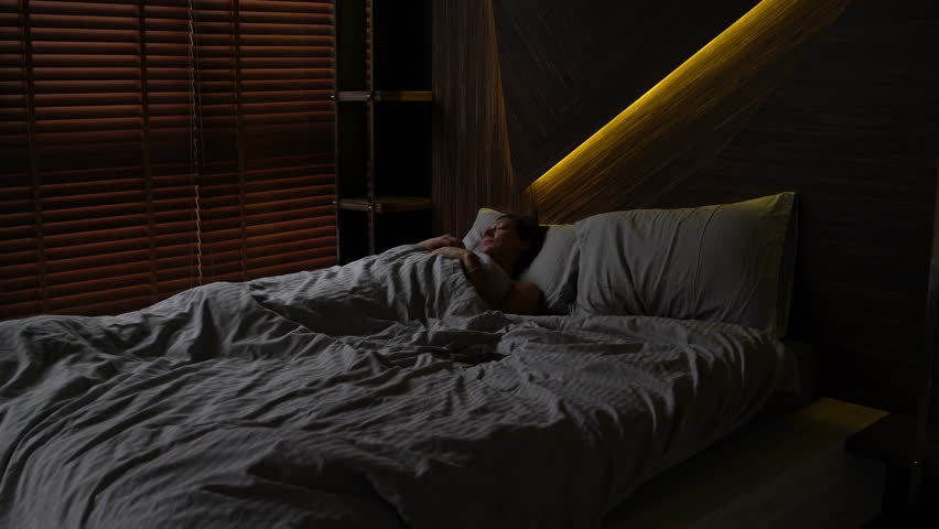 Woman asleep in bed | Shutterstock HD Video #1012952390