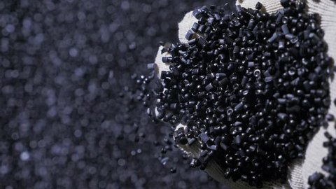 Plastic black gray granulated crumb. Manufacture of plastic water pipes of the factory. Process of making plastic tubes on the machine tool with the use of water and air pressure.