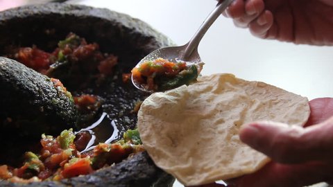 sauce preparation in molcajete, typical Mexican food, tomato, chili and spices, ingredients to prepare spicy sauces