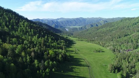 Aerial View. Flight over the Mountain Valley. Sunny summer time [Altai. Siberia] Center of Asia at the junction of Siberian taiga, steppes of Kazakhstan and semi-deserts of Mongolia