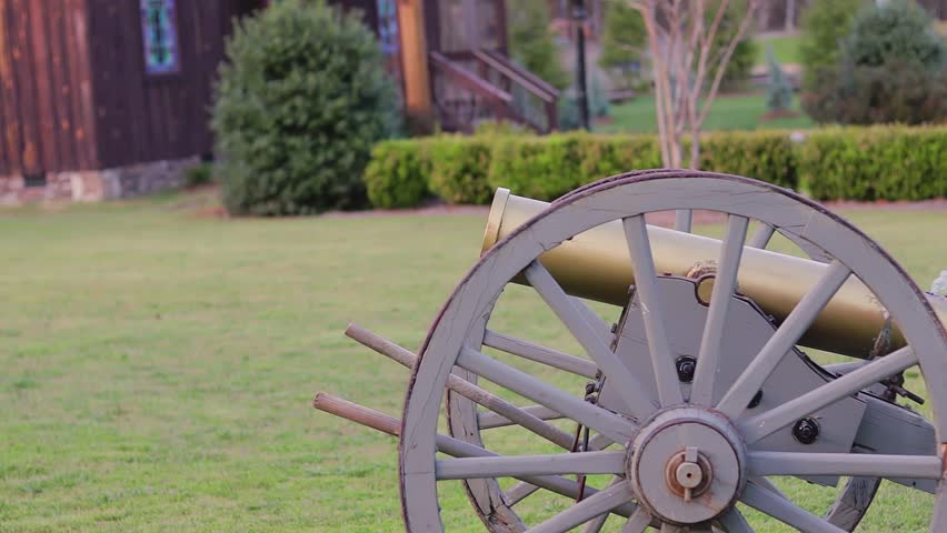 Footage of a rustic cannon firing. Footage is in slow motion.