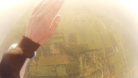 Skydiver opens parachute at sunset with white puffy clouds over a beach. Canopy inflates after skydiving out of an airplane and freefall. Sport skydiving and parachuting.  - Powered by Shutterstock - Get 15% off with code: PIKWIZARD15