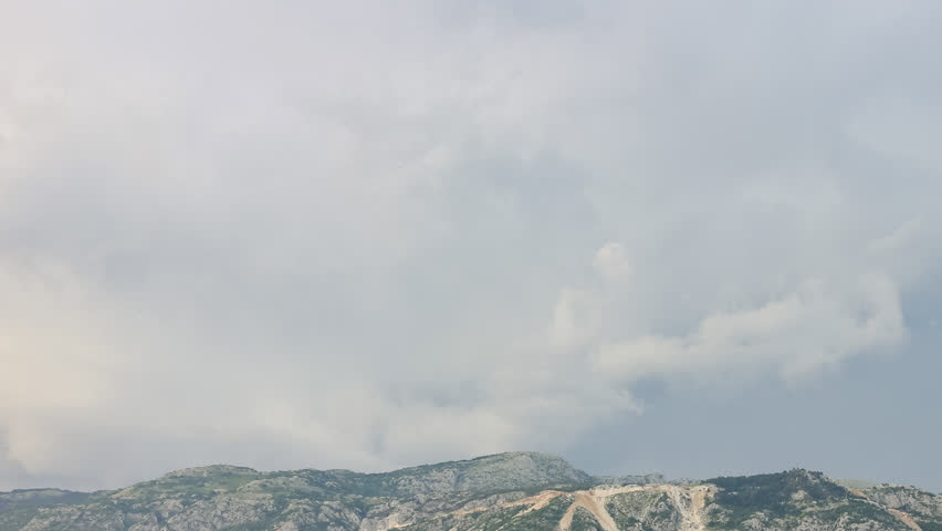 Time lapse, fast moving clouds over mountains at stormy wind in Montenegro timelapse