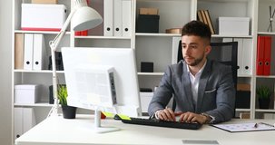 frustrated young businessman working on computer.