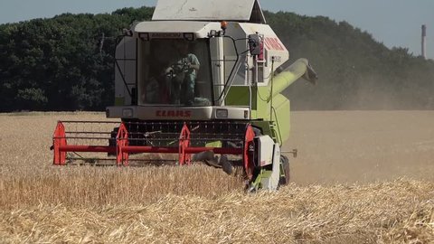 MOERS / GERMANY - JUNE 29 2017 - Combine harvester reaping wheat in the summer