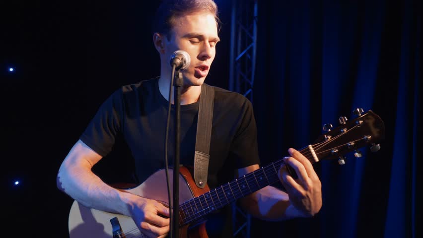 Concert rock band performing on stage with two electric guitars singers. Music video punk, heavy metal or rock group. Slow motion instrument playing band of two men.