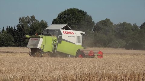 MOERS / GERMANY - JUNE 29 2017 - Combine harvester reaping wheat in the summer