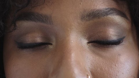 close up beautiful african american woman eyes open looking at camera blinking healthy eyesight
