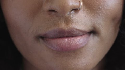 close up of african american woman lips smiling happy beautiful perfect skin wearing nose ring macro