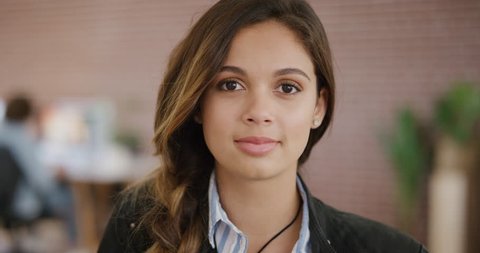 portrait of beautiful young hispanic woman smiling enjoying happy successful career office workspace independent female intern