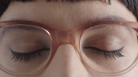 close up young woman brown eyes opening looking at camera wearing stylish glasses eyesight vision