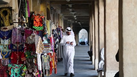 QATAR, DOHA, MARCH 22, 2018: People at Souq Waqif or the standing market - eastern bazaar in Doha - capital and most populous city in Qatar, Persian Gulf, Arabian Peninsula