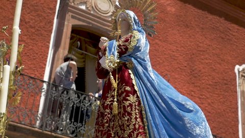 SAN MIGUEL DE ALLENDE, MEXICO - CIRCA MARCH 2016 - Virgin Mary statue with a blue robe blowing in the wind in slow motion during an Easter parade during Semana Santa holy week celebration