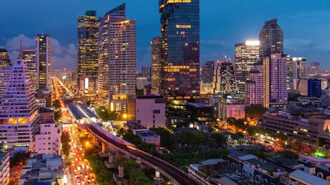 Timelapse day to night traffic during rush hour in business area at Bangkok,Thailand.Bangkok is the most populated city in Southeast Asia.