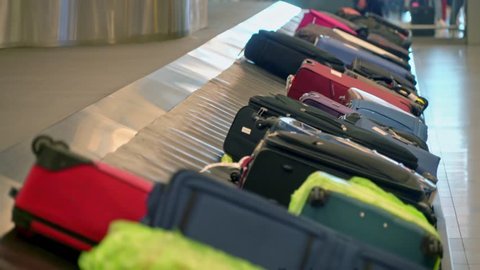 New York, United States, June 10, 2018: Luggage on baggage carousel waiting for travelors at the depature hall of John F. Kennedy airport