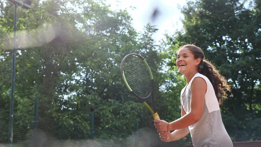 Young girl blocking the ball with the tennis racket during the training | Shutterstock HD Video #1013020733