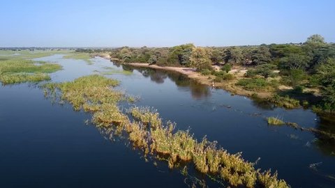 Aerial landscape in Okavango delta on Namibia and Angola border. River with shore and green vegetation after rainy season.