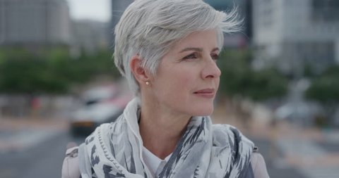 portrait beautiful senior woman turns head looking confident middle aged female enjoying successful urban lifestyle in city slow motion real people series