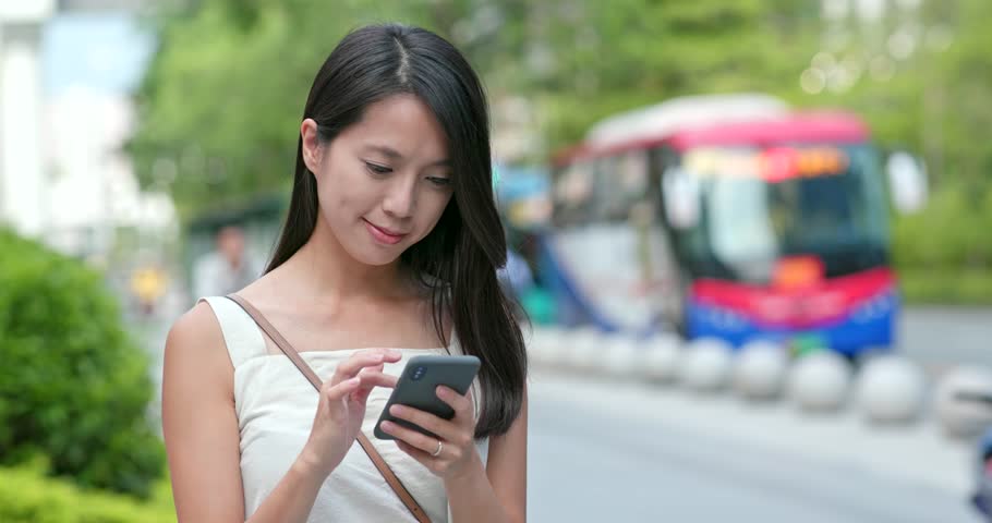 Woman use the app on mobile phone at outdoor