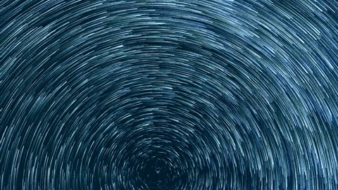 Starry sky time lapse with the star trails like comets. North Pole Star, stars rotating in dark night blue sky, exotic horizone panoramic footage, abstract background.