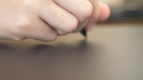 Closeup on hand using graphic tablet. 4k, slow motion