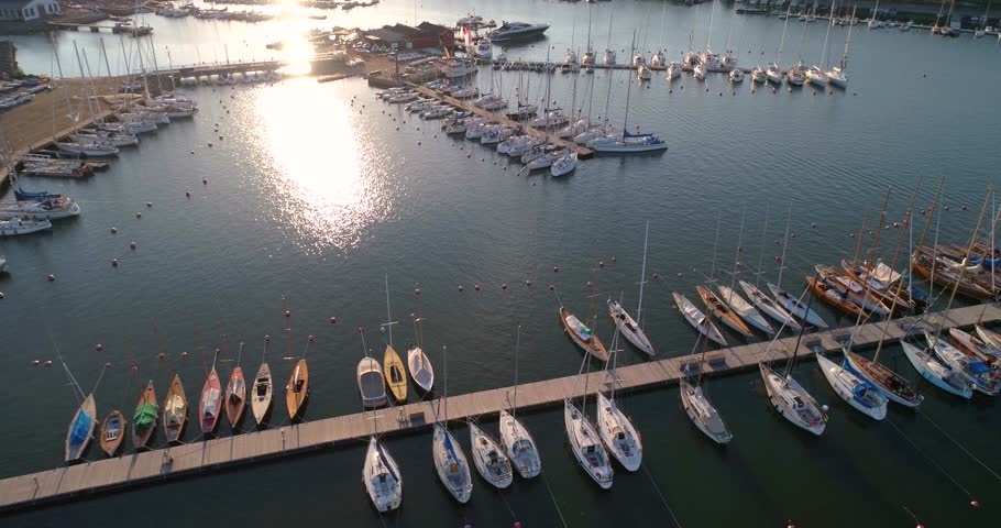 Boats at a harbour, C4K aerial view of a island full of yachts and boat at liuskasaari harbor, on a sunny summer evening dusk, Helsinki, Uusimaa, Finland