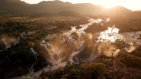 Sunrise in waterfall Epupa Falls on the Kunene River in Northern Namibia and Southern Angola. Aerial view