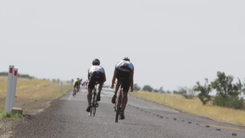 A two shot of two bikers riding in slow motion