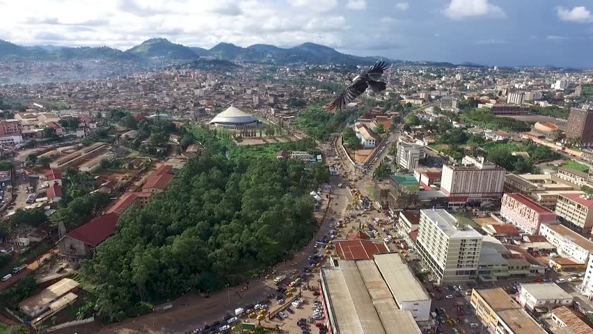 Drone flyover city of Yaoundé park at the center of town Royalty-Free Stock Footage #1013078615