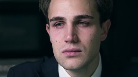 Sad depressed young attractive Buisness man crying alone in his office