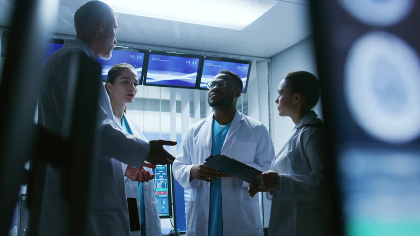 Low Angle Shot of the Meeting of the Team of Medical Scientists in the Brain Research Laboratory. Neurologists / Neuroscientists Having Analytical Discussion. Shot on RED EPIC-W 8K Helium  Camera.