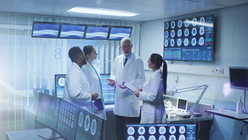 Meeting of the Team of Medical Scientists in the Brain Research Laboratory. Neurologists / Neuroscientists Having Heated Discussion Surrounded by Monitors Showing CT, MRI Scans. Shot on RED EPIC-W 8K.