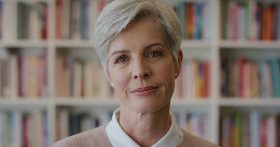 Portrait of beautiful middle aged business woman laughing, enjoying professional lifestyle success