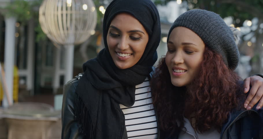 Portrait of young diverse women friends using smartphone taking selfie | Shutterstock HD Video #1013087807