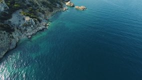 Aerial shot along the stone shores of the mediterranean sea. 4k drone video forward.