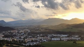 Time-lapse zoom video: Magic Warm Sunset with fast floating clouds over the mountain town. Dolny Kubin, Slovakia. 