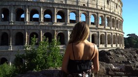 Amazing young woman walking near Colosseum, Rome, Italy. Clip in 4k format
