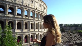 Amazing young woman walking near Colosseum, Rome, Italy. Clip in 4k format