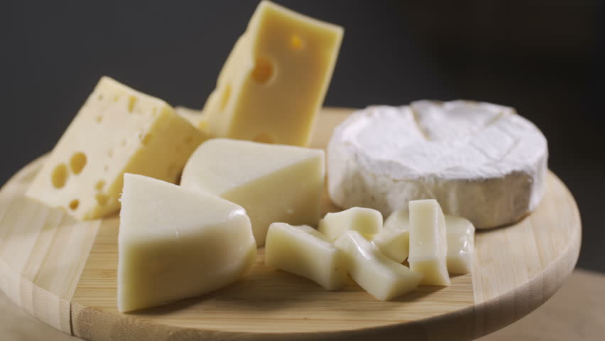 Pieces of different cheeses on plate | Shutterstock HD Video #1013103872
