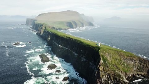 Flying above the dramatic coastline of Mykines island in Faroe Islands.